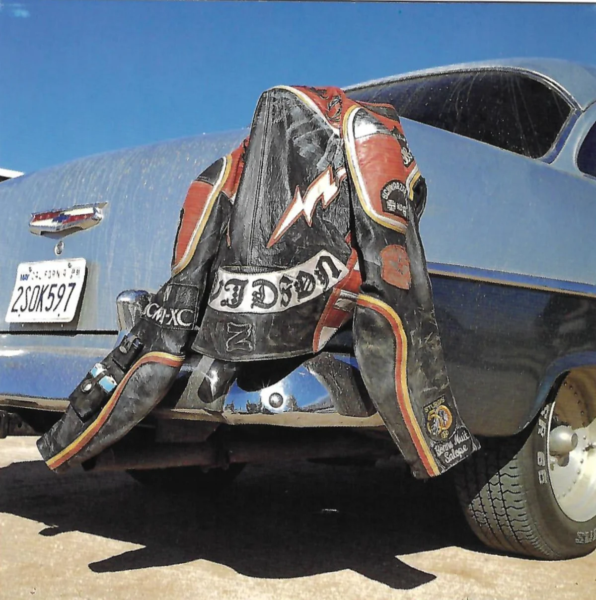 Front of Mickey Rourke's Christmas card: a leather biker jacket thrown over the back of a car